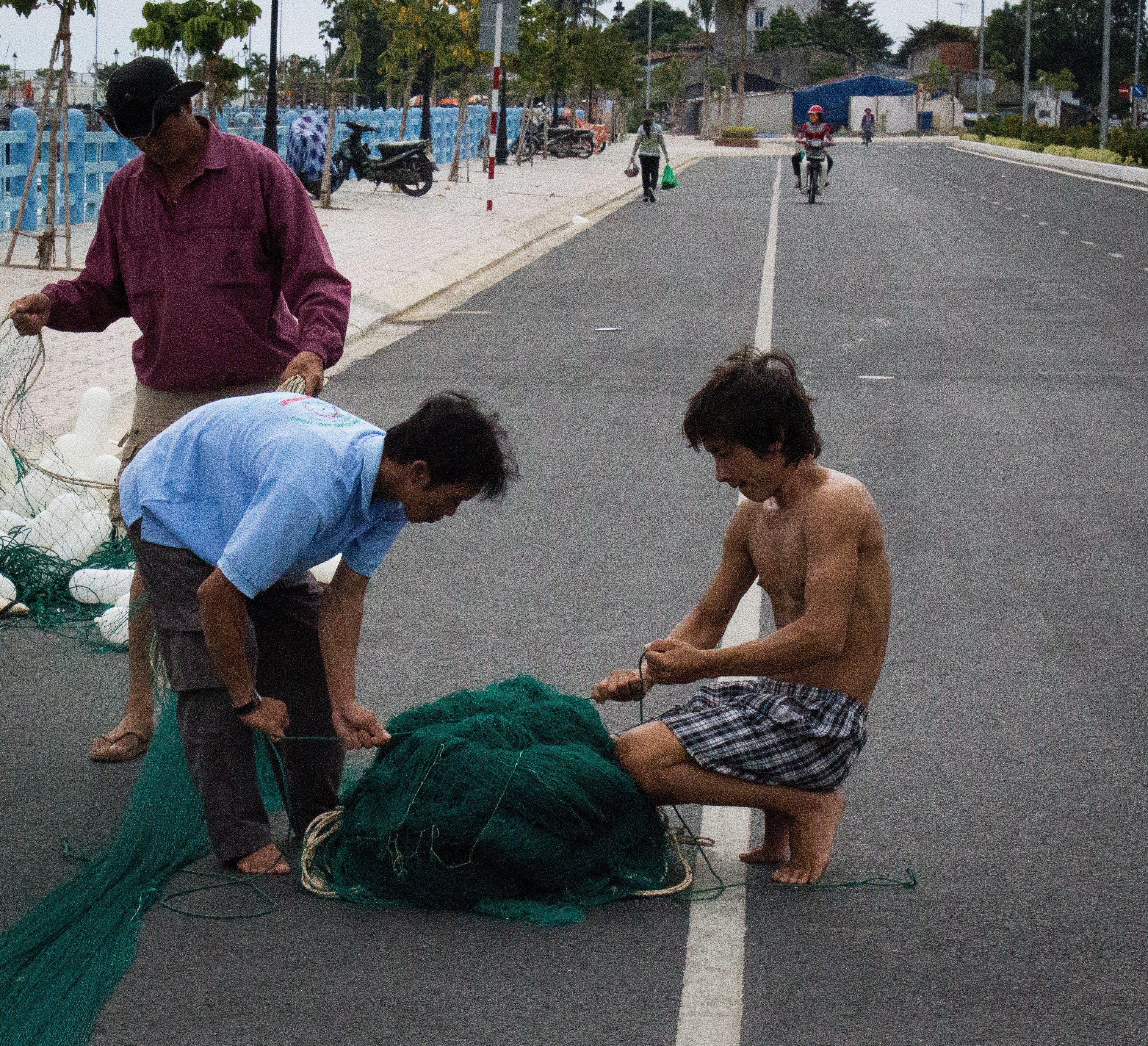 Nha Trang Fisherman preparing new fishing nets